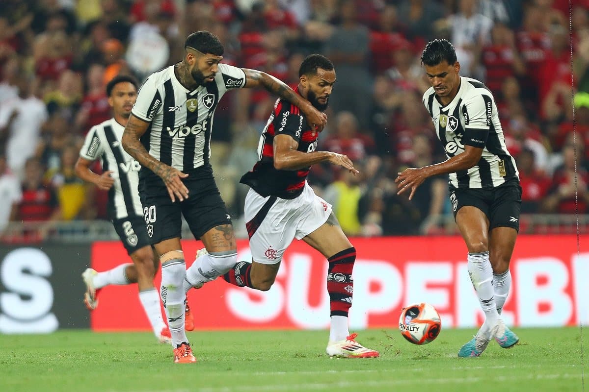 Juninho tenta driblar jogadores do Botafogo em clássico