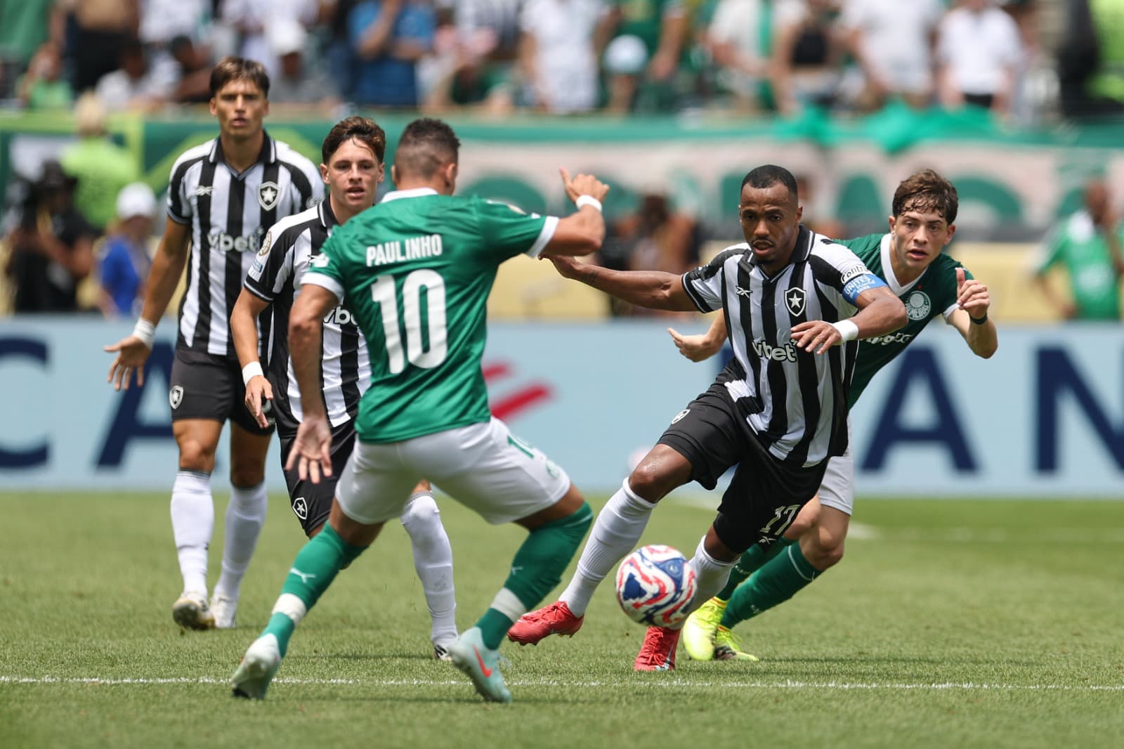 Marlon Freitas #17 of Botafogo runs with the ball while under pressure from Paulinho #10 of Palmeiras during the FIFA Club World Cup 2025 round of 16 match between SE Palmeiras and Botafogo FR at Lincoln Financial Field on June 28, 2025 in Philadelphia, P