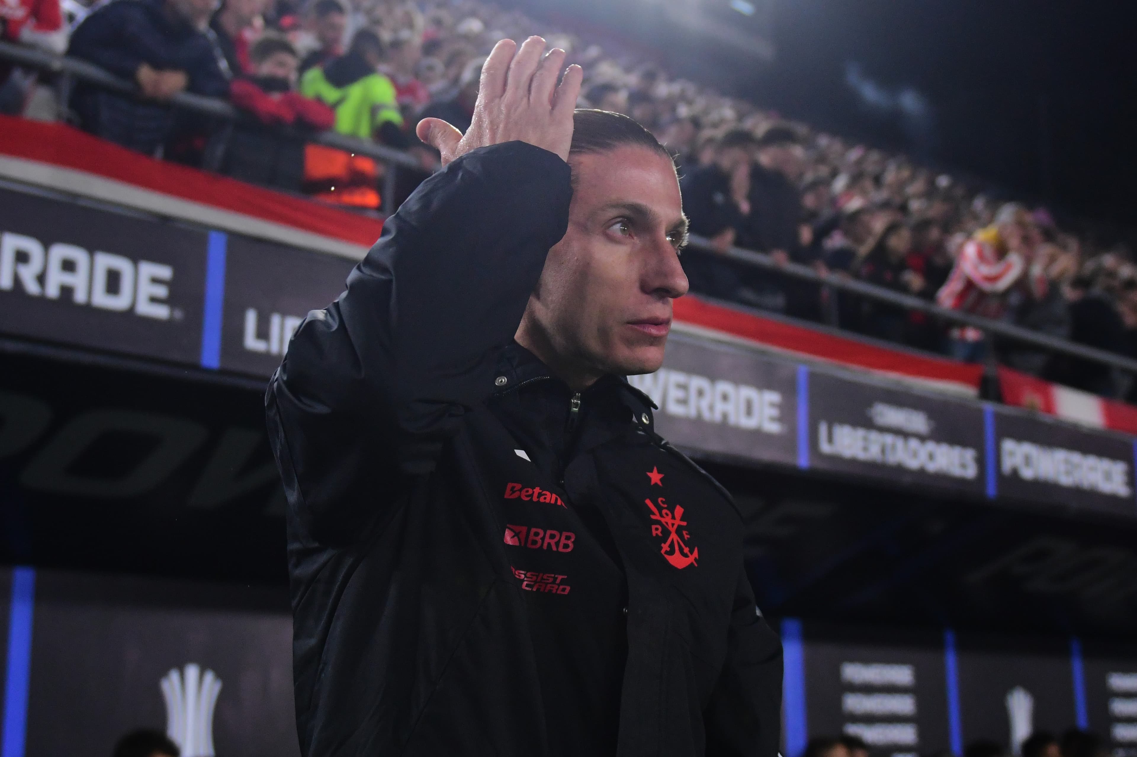 Filipe Luís ajeita o cabelo durante Estudiantes x Flamengo