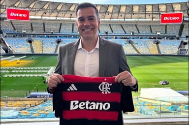 Guilherme Figueiredo, da Betano, sorri com camisa do Flamengo em mãos no Maracanã