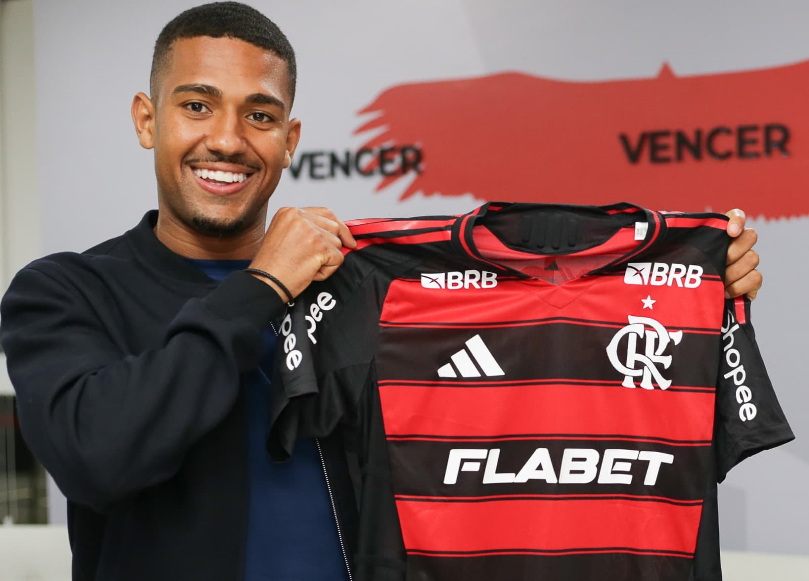 Samu Lino sorri e segura camisa do Flamengo após anúncio do clube