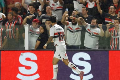 Ferreirinha, atacante do São Paulo, comemora gol marcado contra o Flamengo em frente a torcedores do clube que celebram o feito nas arquibancadas do estádio Vila Belmiro