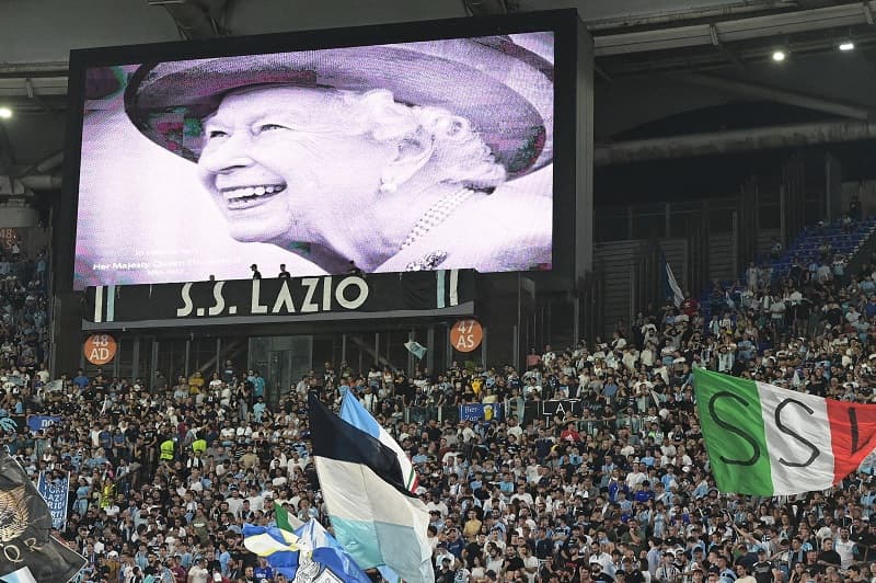 A portrait of Britain's Queen Elizabeth II is displayed on a giant screen following the announcement of her death, prior to the start of the UEFA Europa League Group F first leg football match between SS Lazio and Feyenoord Rotterdam at the Olympic stadiu