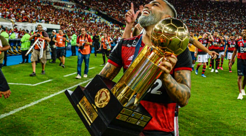 Gabigol com a taça da Recopa Sul-Americana 2020, contra o Independiente Del Valle; documento sobre o terreno do estádio e as últimas notícias do Flamengo