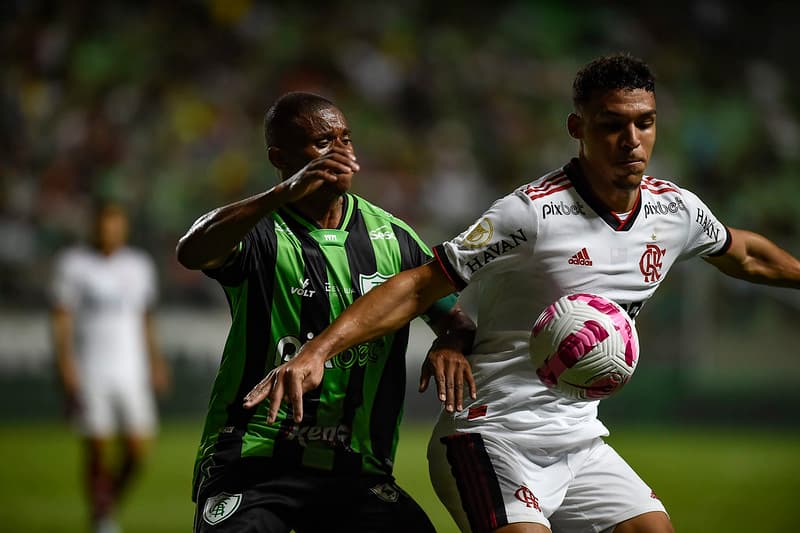 Victor Hugo disputa bola contra jogador do América-MG; Flamengo venceu o jogo por 2x1