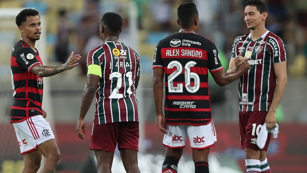 Allan (E) e Alex Sandro (2º D) do Flamengo cumprimentam Jhon Arias (2º E) e Paulo Henrique Ganso (D) do Fluminense no final da partida entre Flamengo e Fluminense como parte do Brasileirão 2024 no Estádio do Maracanã em 17 de outubro de 2024 no Rio de Jan