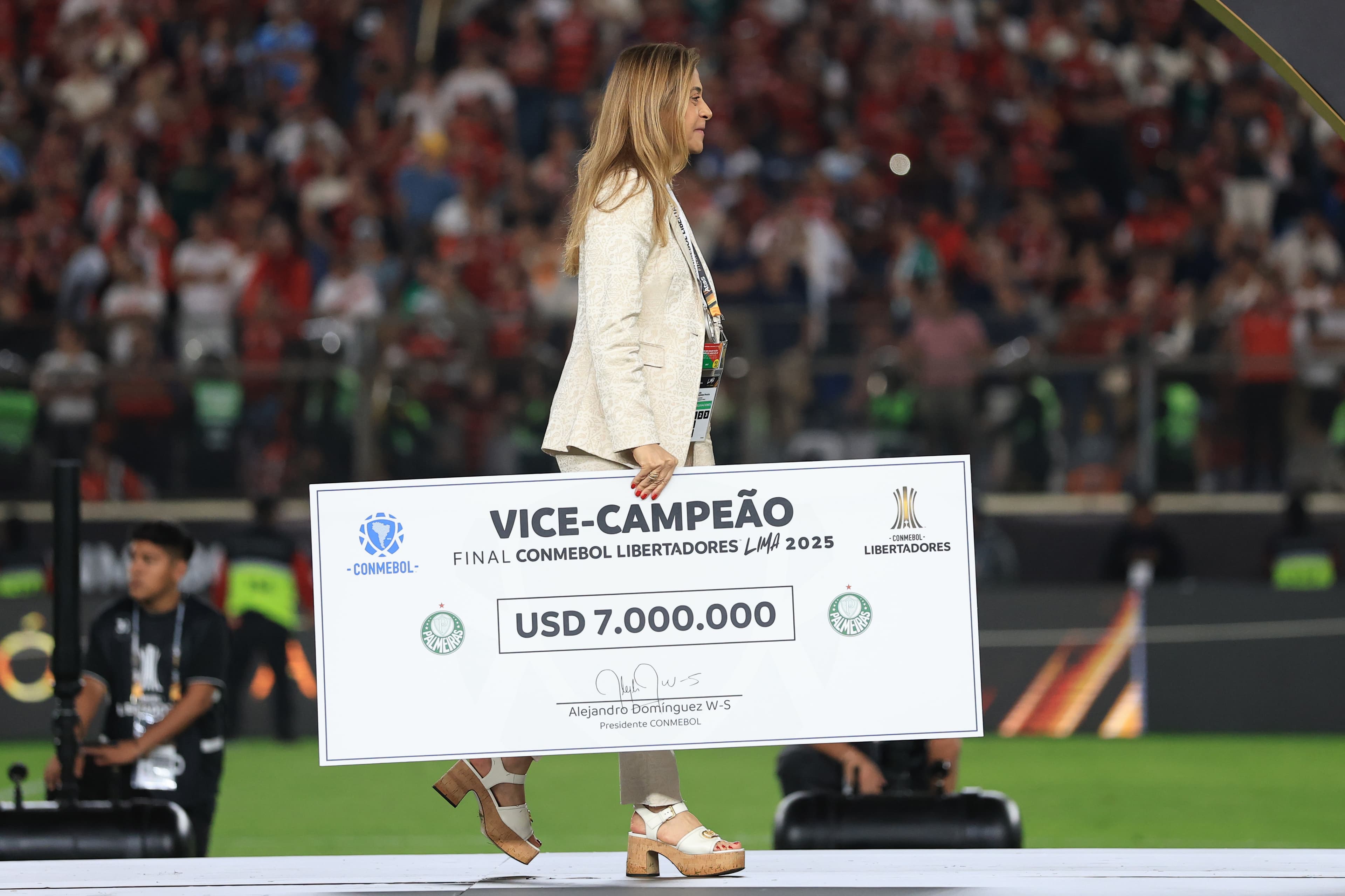 Leila Pereira, presidente do Palmeiras, carregando o cheque de 7 milhões de dólares, dado ao vice-campeão da Libertadores 2025