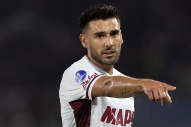 Eduardo Salvio, do Lanús, aponta para frente com a mão direita